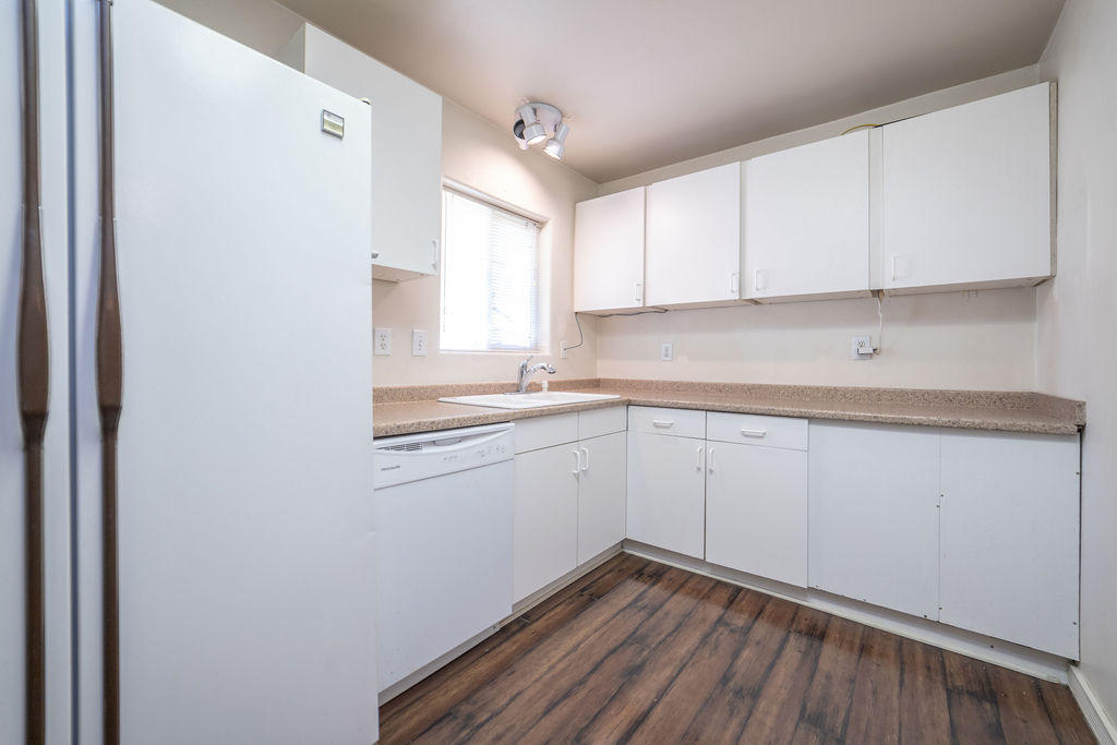 19132 Pumice Butte Road Bend, OR 97702 - Photo 22 of 49 a kitchen with sink cabinets and wooden floor
