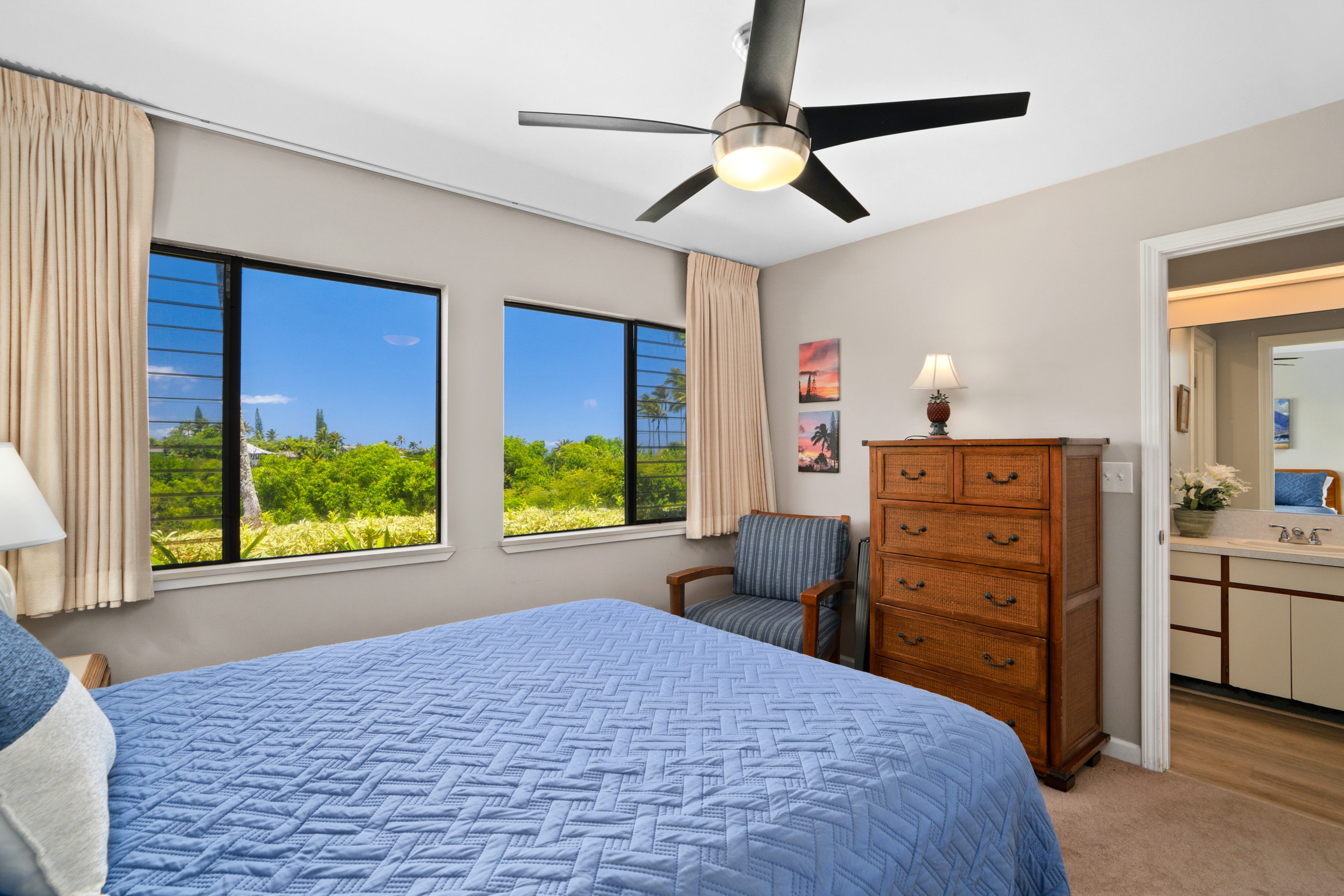 3830 Edward Road, Unit 12D Princeville, HI 96722 - Photo 18 of 30 a bedroom with a bed and a dresser next to a window