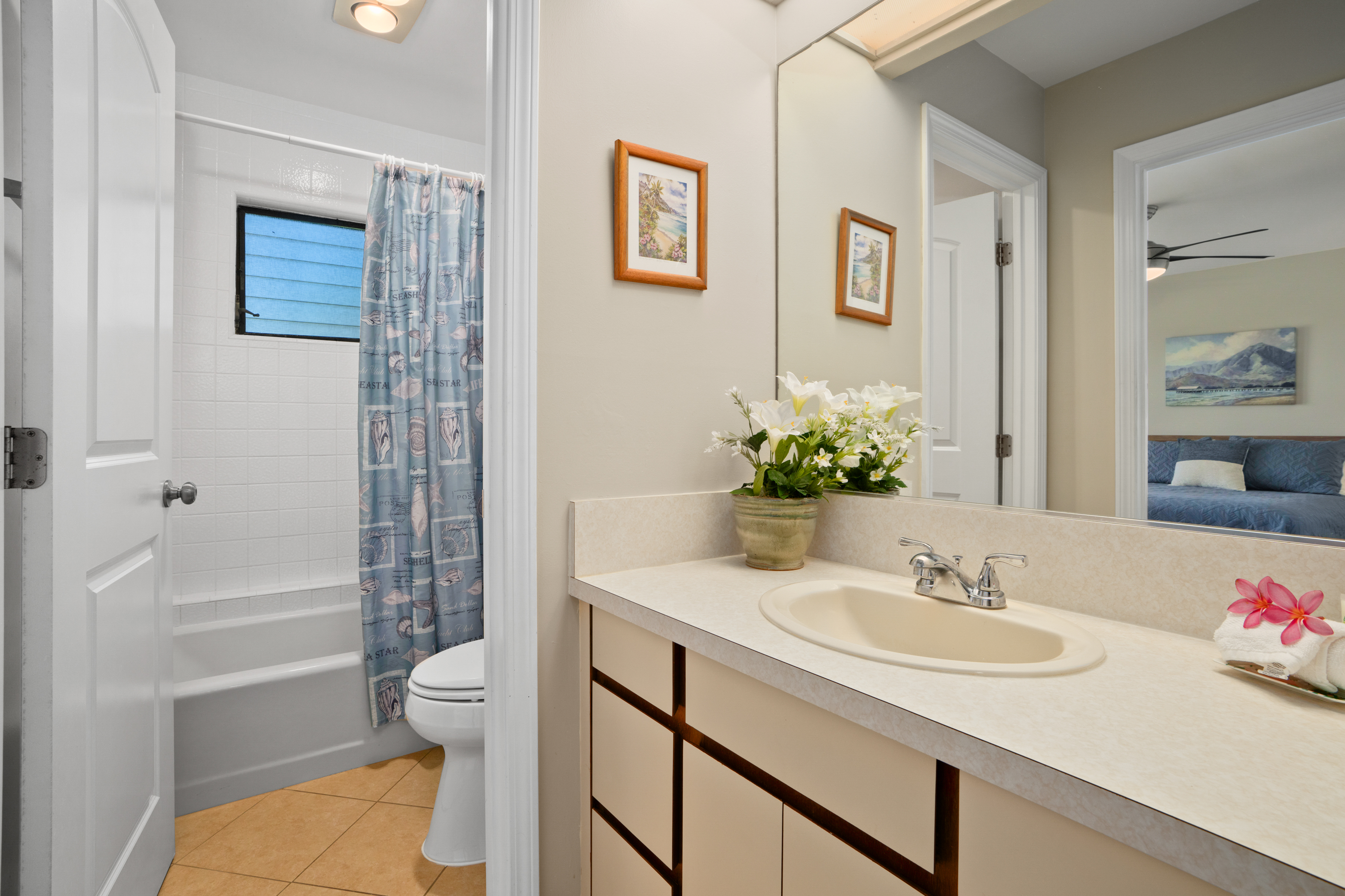 3830 Edward Road, Unit 12D Princeville, HI 96722 - Photo 19 of 30 a bathroom with a sink toilet and shower
