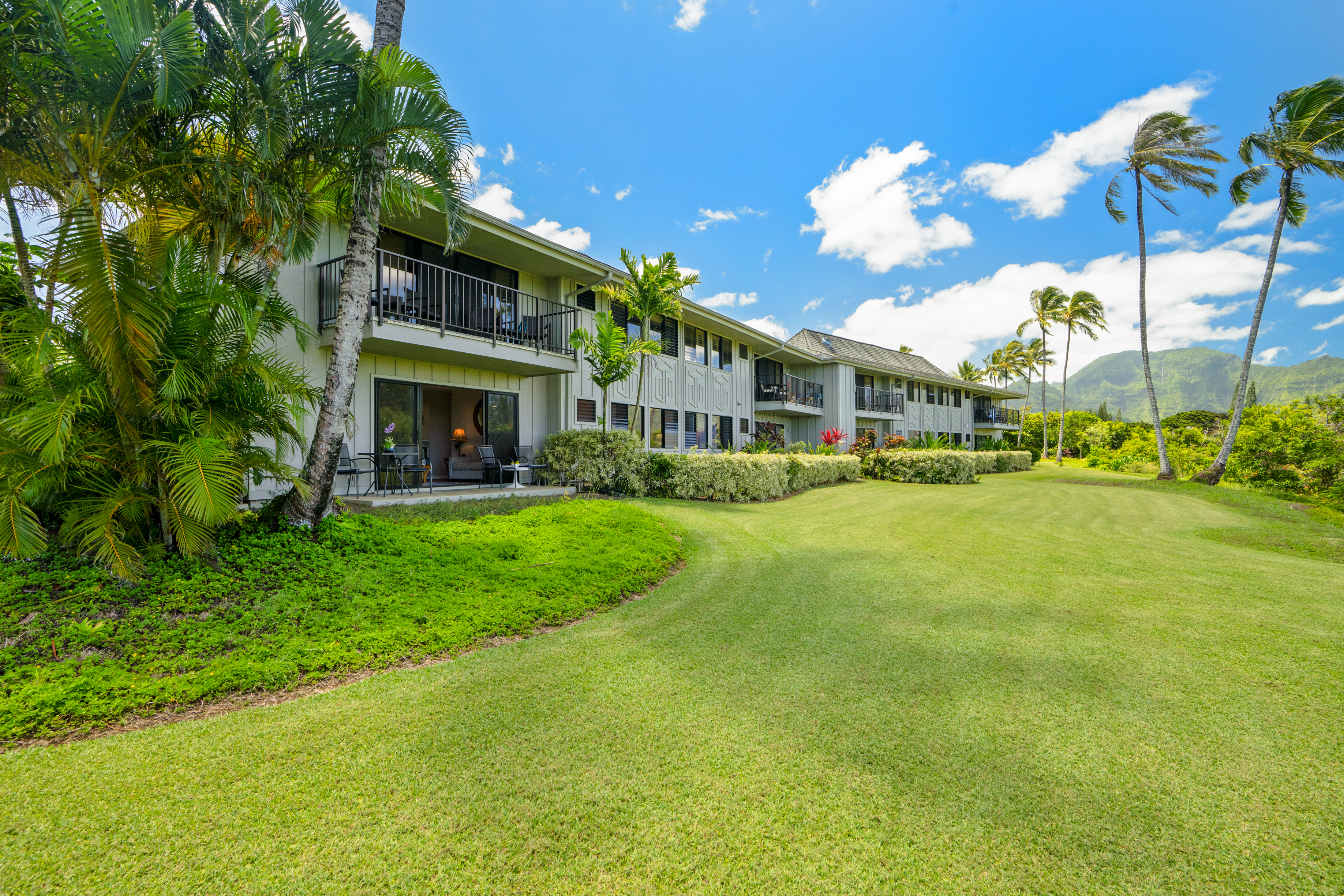3830 Edward Road, Unit 12D Princeville, HI 96722 - Photo 21 of 30 a front view of a building with a garden