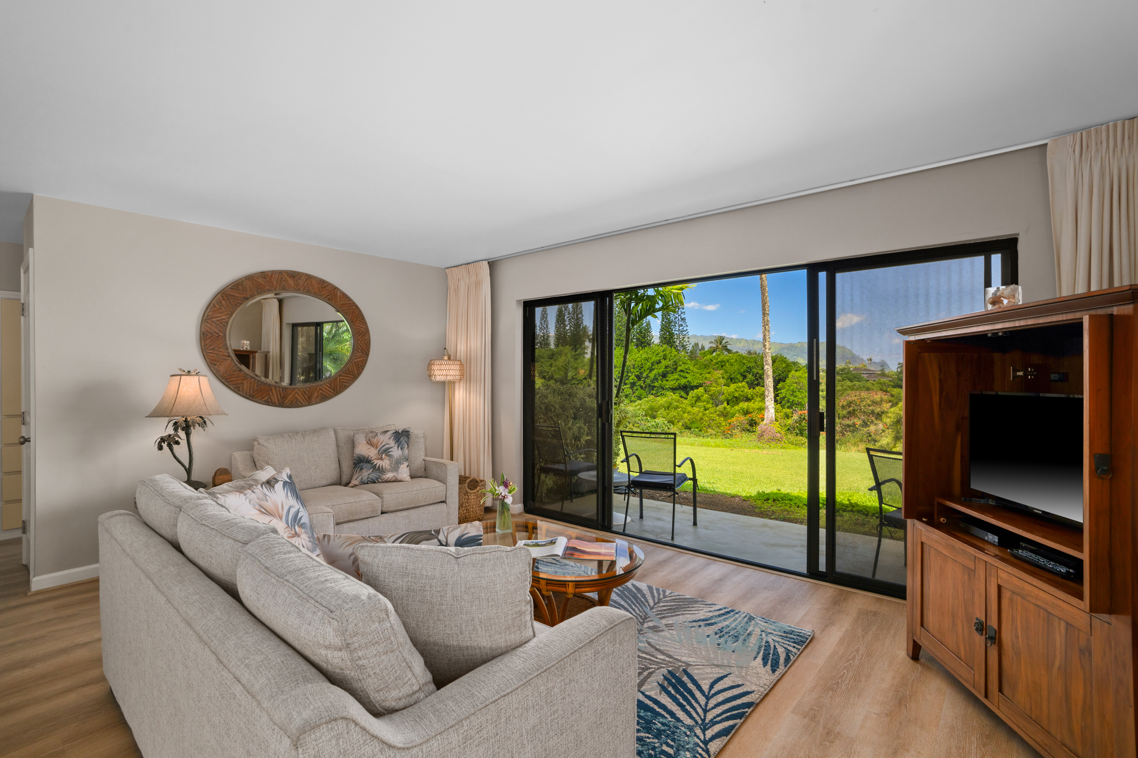 3830 Edward Road, Unit 12D Princeville, HI 96722 - Photo 3 of 30 a living room with furniture and a flat screen tv
