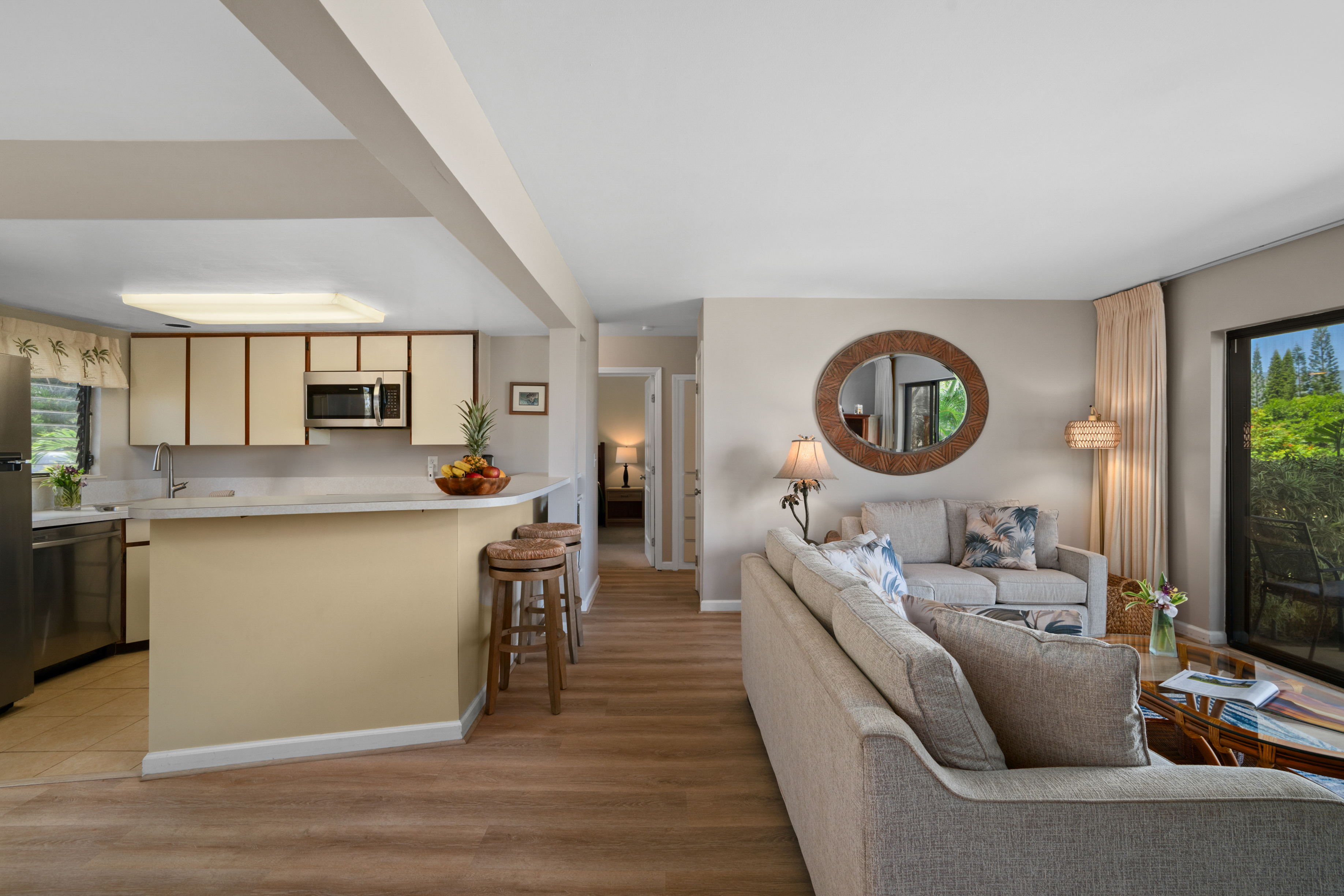3830 Edward Road, Unit 12D Princeville, HI 96722 - Photo 8 of 30 a living room with stainless steel appliances furniture a rug kitchen view and a fireplace