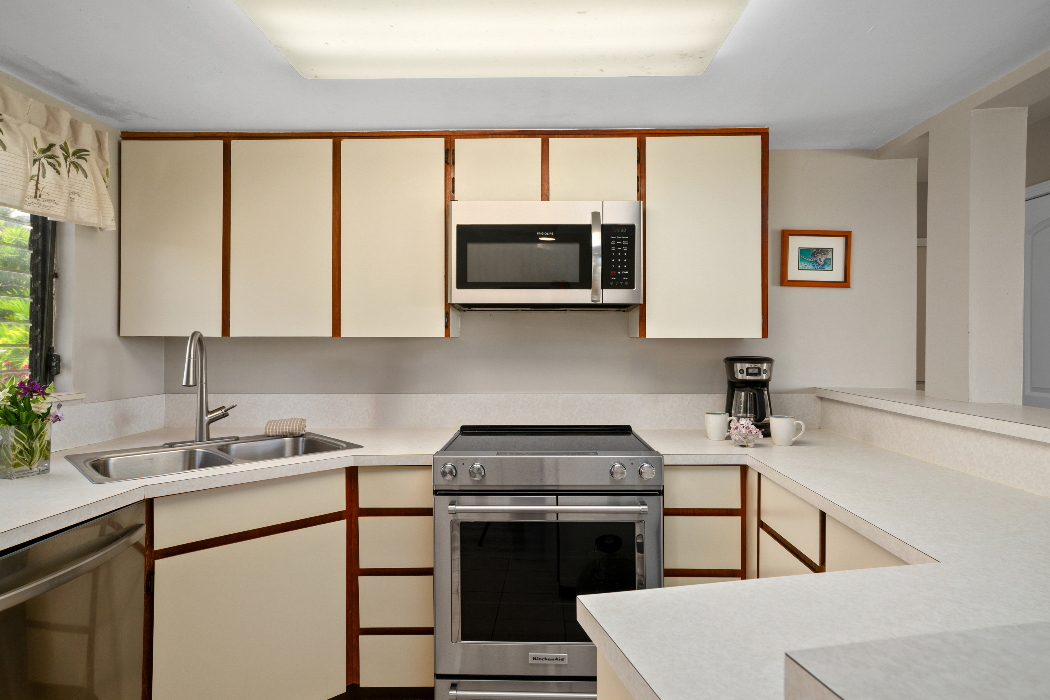 3830 Edward Road, Unit 12D Princeville, HI 96722 - Photo 10 of 30 a kitchen with a sink stove and microwave
