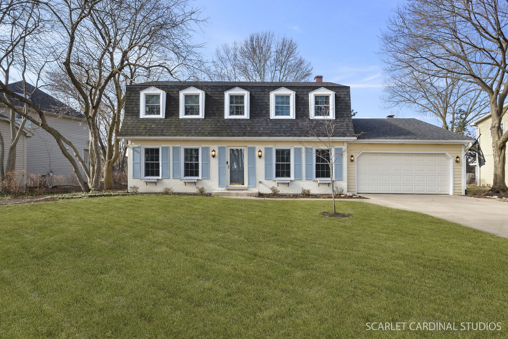 a front view of a house with a garden