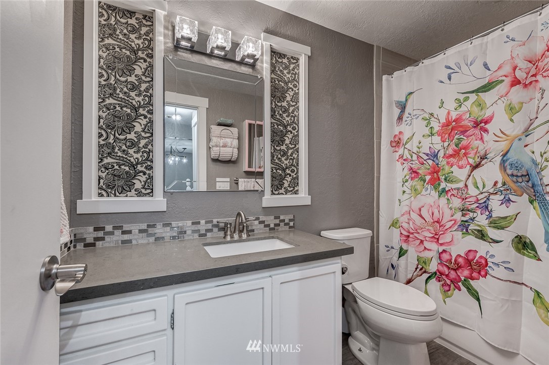 6918 Lower Ridge Road, Unit B Everett, WA 98203 - Photo 11 of 25 a bathroom with a sink and a mirror