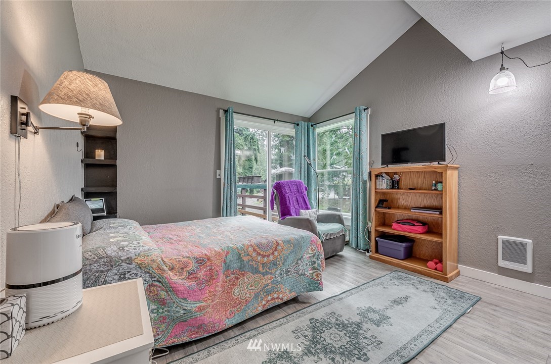 6918 Lower Ridge Road, Unit B Everett, WA 98203 - Photo 12 of 25 a bedroom with a bed and a flat screen tv