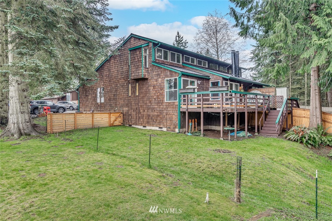 6918 Lower Ridge Road, Unit B Everett, WA 98203 - Photo 25 of 25 a view of a house with a backyard