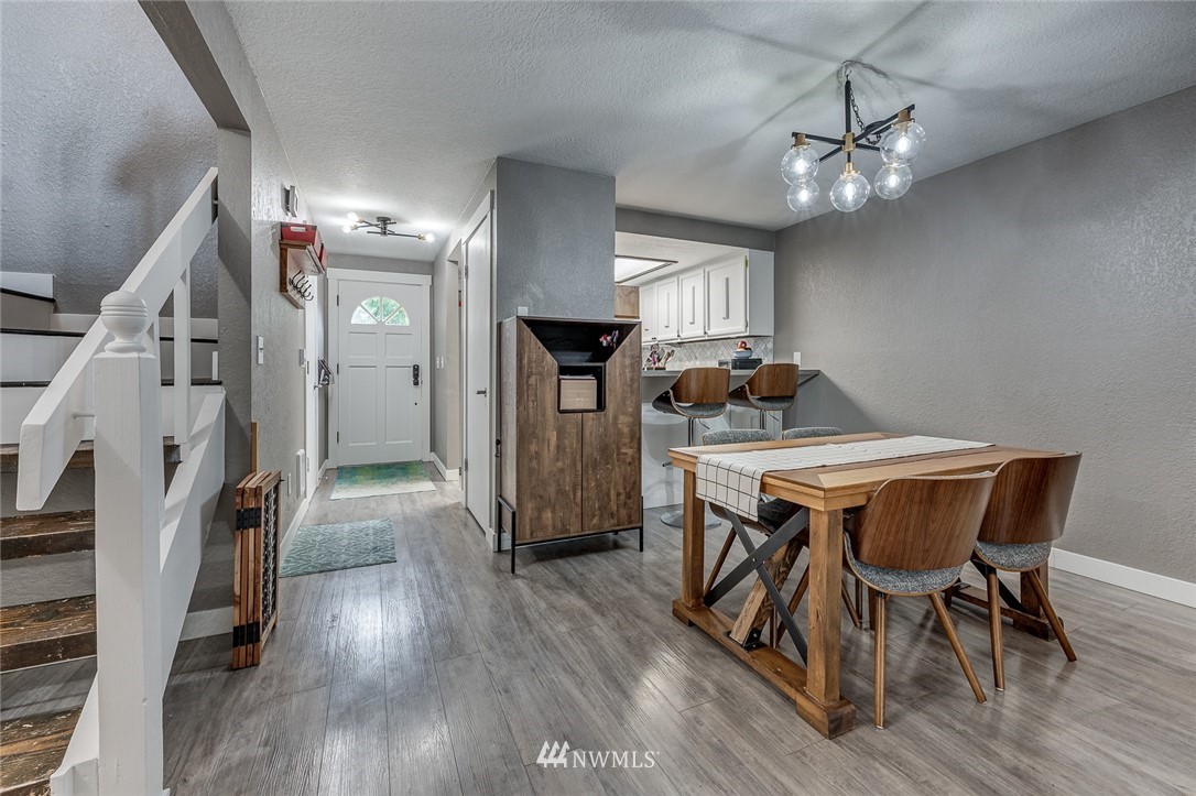 6918 Lower Ridge Road, Unit B Everett, WA 98203 - Photo 4 of 25 a dining room with furniture and wooden floor