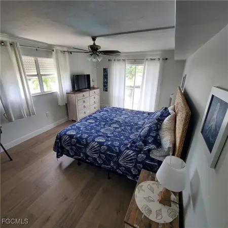 a bedroom with a bed window and a table