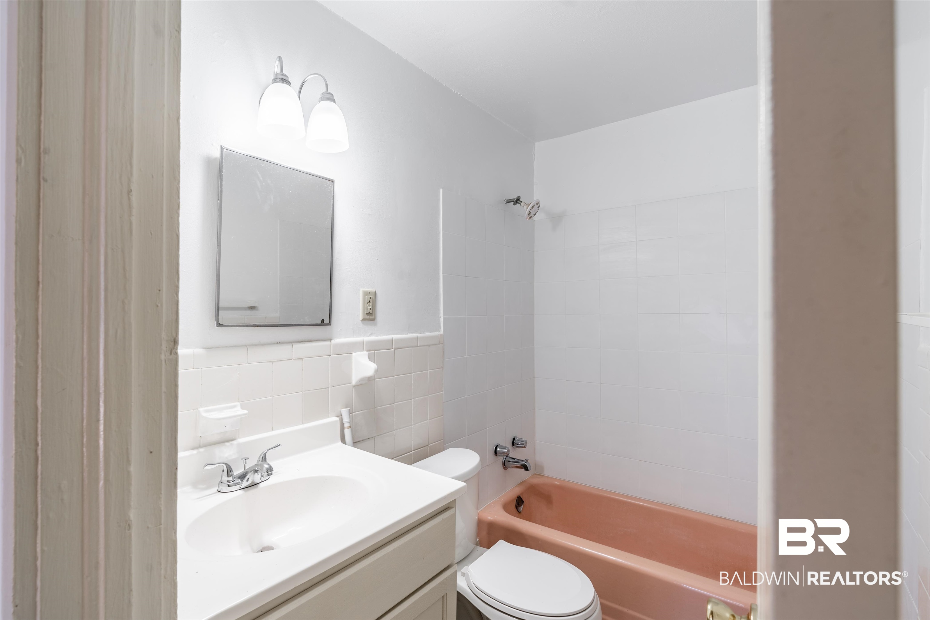 3900 Brookmont Drive Mobile, AL 36605 - Photo 11 of 19 Full bathroom with toilet, tiled shower / bath combo, tile walls, and vanity