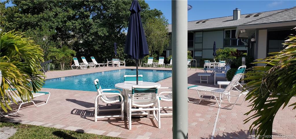 8227 Southeast Croft Circle Hobe Sound, FL 33455 - Photo 16 of 18 a view of backyard with outdoor seating and plants