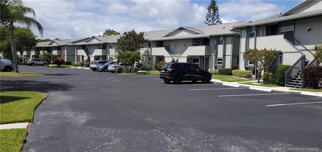 8227 Southeast Croft Circle Hobe Sound, FL 33455 - Photo 17 of 18 a car parked in front of a building