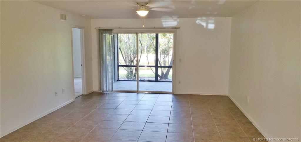 8227 Southeast Croft Circle Hobe Sound, FL 33455 - Photo 5 of 18 an empty room with windows and entrance