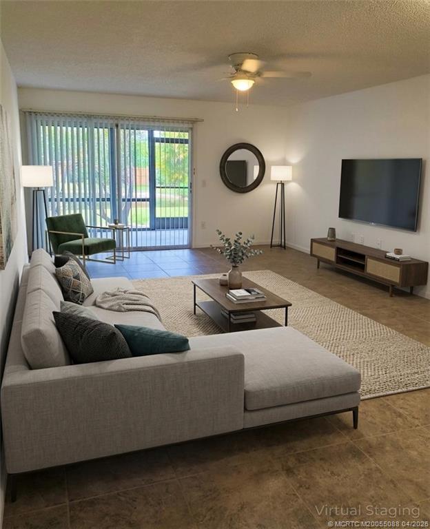 8227 Southeast Croft Circle Hobe Sound, FL 33455 - Photo 6 of 18 a living room with furniture and a flat screen tv