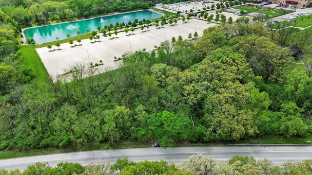 an aerial view of a house with a yard and lake view