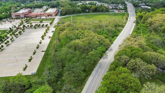 an aerial view of a house with a garden and swimming pool