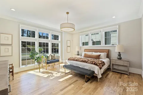 a bedroom with a bed wooden floor and furniture