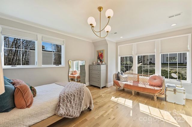 a bedroom with furniture and a large window