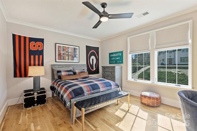 a bedroom with a bed and glass walk in closet