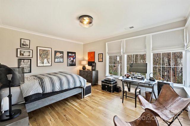 a bedroom with a large bed and a large window