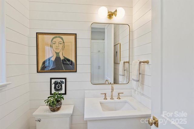 a kitchen with a sink a washer and dryer next to a window