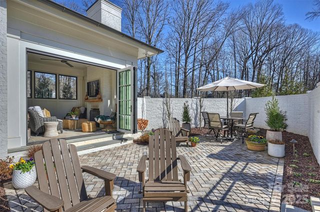 a view of a patio with two chairs and a umbrella