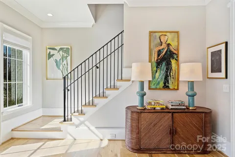 a living room with furniture and a painting on the wall