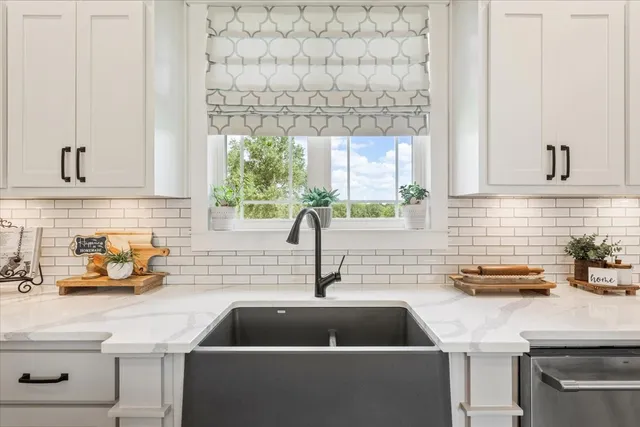 a kitchen with a sink cabinets and a window