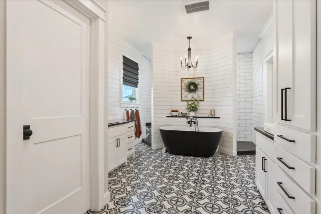 a bathroom with a bathtub sink and mirror