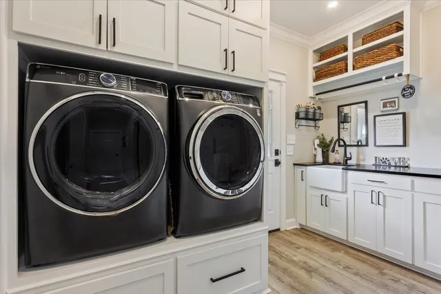 a utility room with sink dryer and washer