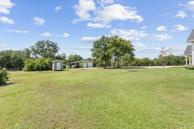 a view of a house with a yard and garage