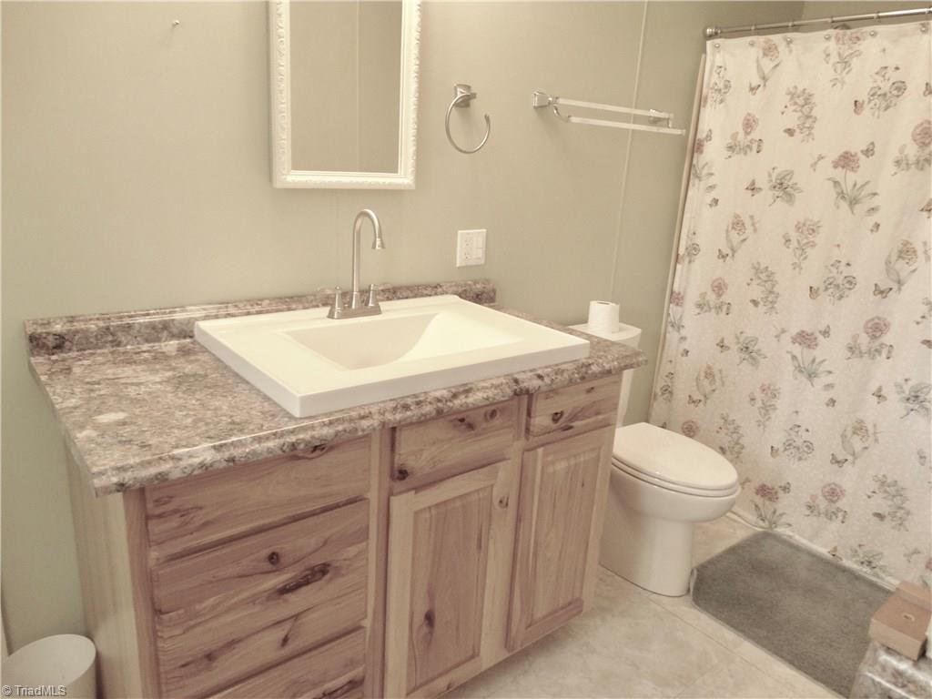 5044 Sitka Road Walkertown, NC 27051 - Photo 13 of 15 Guest Bath has been updated with a tall sink with custom cabinet and lots more storage!