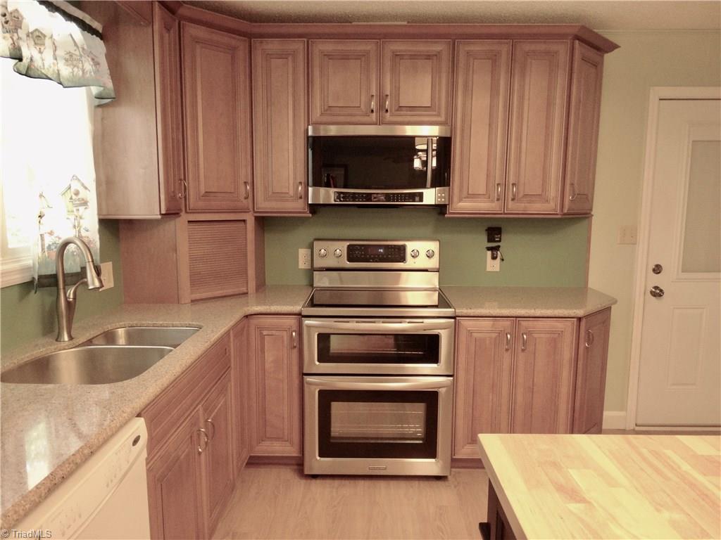 5044 Sitka Road Walkertown, NC 27051 - Photo 3 of 15 Check out the cabinet on the bottom right of the range oven. There is a center island that is included and there is a place to hide that toaster to the left of the stove!