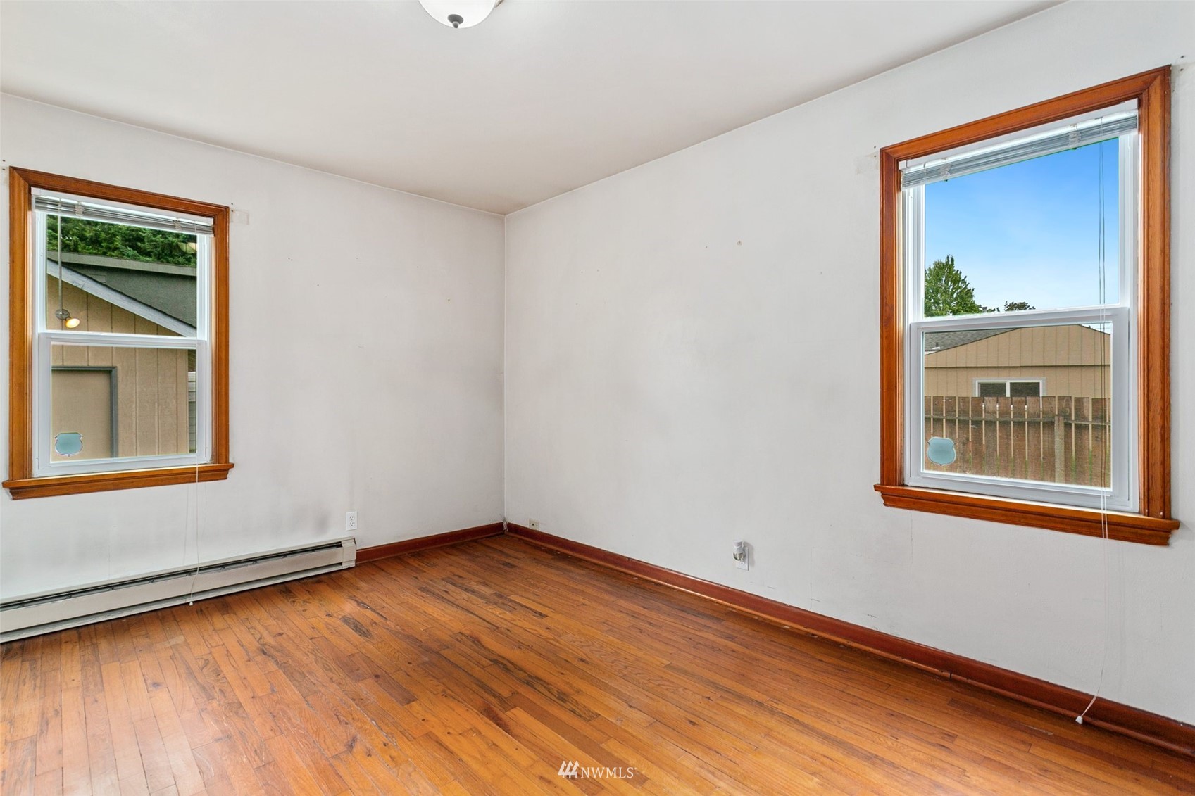 218 West Crow Street Kent, WA 98032 - Photo 17 of 25 a view of an empty room with wooden floor and a window