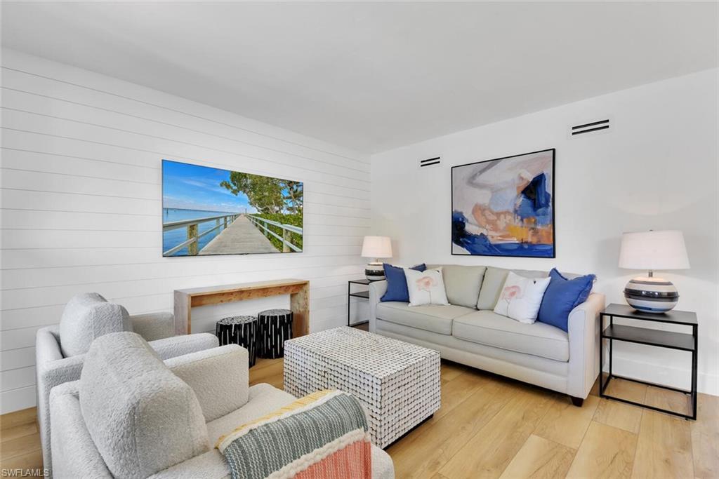 980 7th Avenue South, Unit 204 Naples, FL 34102 - Photo 1 of 18 a living room with furniture and a fireplace