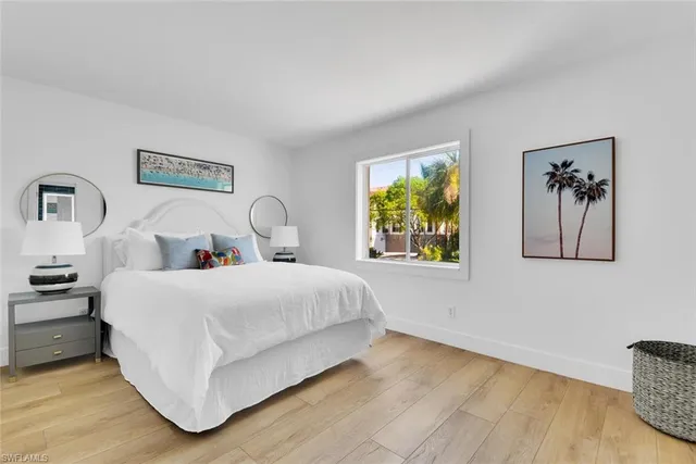 a bedroom with bed and painting on the wall