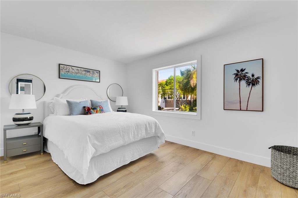 980 7th Avenue South, Unit 204 Naples, FL 34102 - Photo 11 of 18 a bedroom with bed and painting on the wall