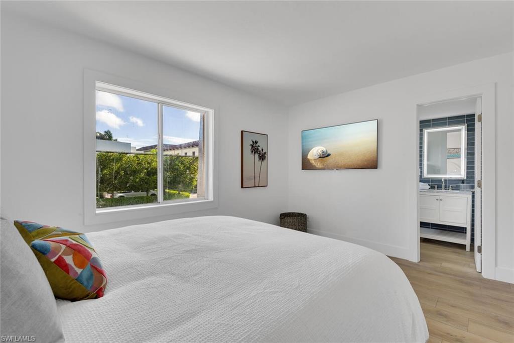 980 7th Avenue South, Unit 204 Naples, FL 34102 - Photo 12 of 18 a bedroom with a bed and a painting on the wall