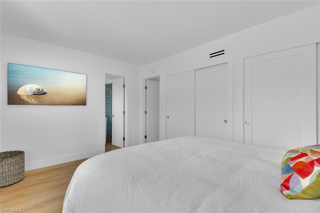 980 7th Avenue South, Unit 204 Naples, FL 34102 - Photo 13 of 18 a bedroom with a bed and a painting on the wall