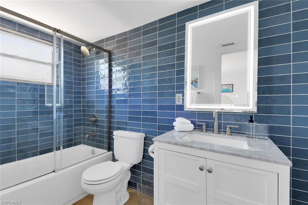 980 7th Avenue South, Unit 204 Naples, FL 34102 - Photo 14 of 18 a bathroom with a sink toilet and shower