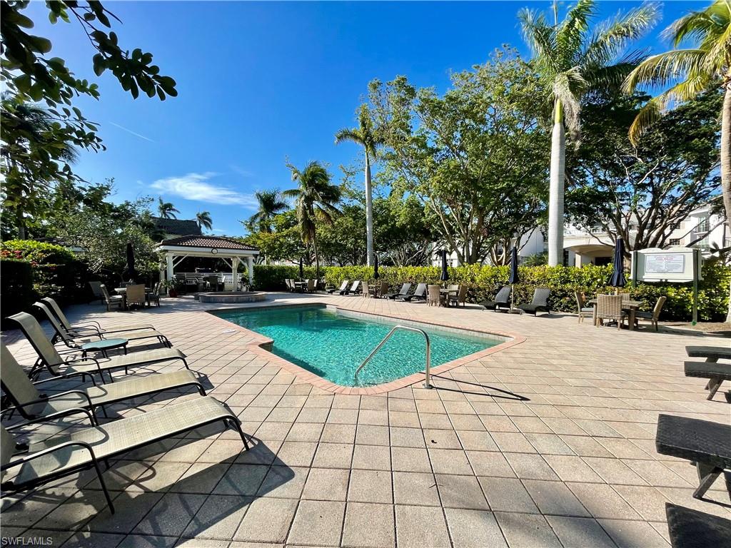 980 7th Avenue South, Unit 204 Naples, FL 34102 - Photo 17 of 18 a swimming pool with yard and outdoor seating