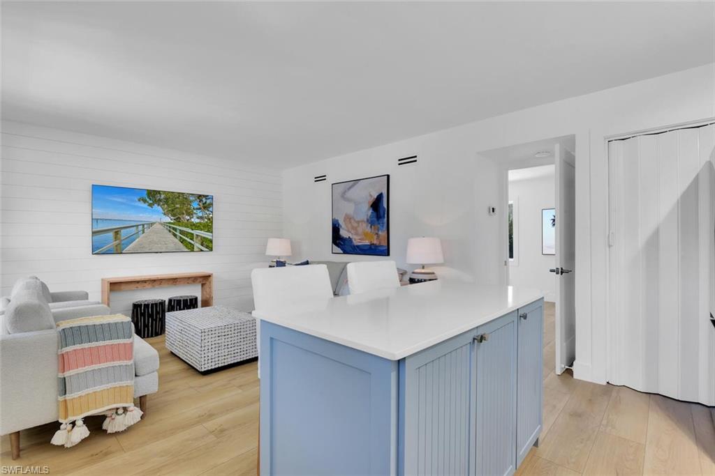 980 7th Avenue South, Unit 204 Naples, FL 34102 - Photo 6 of 18 a living room with furniture and a wooden floor