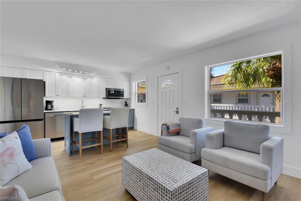 980 7th Avenue South, Unit 204 Naples, FL 34102 - Photo 8 of 18 a living room with furniture and a large window