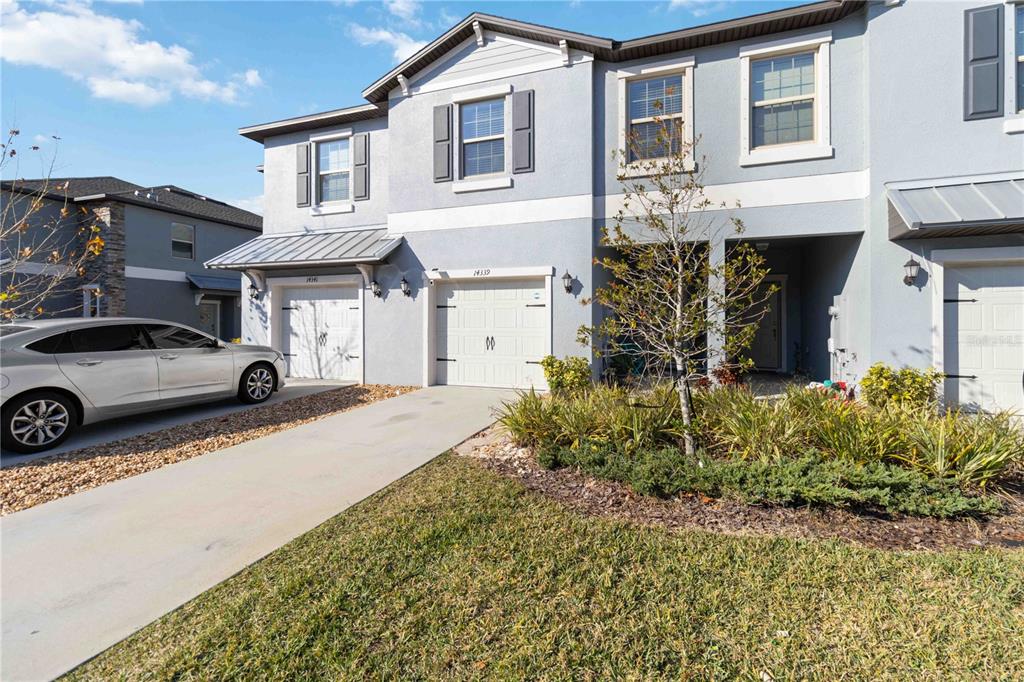 a front view of a house with garden