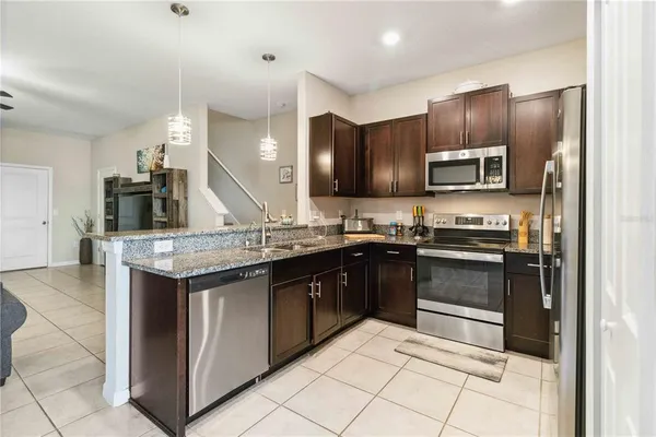 a kitchen with stainless steel appliances granite countertop a stove and a sink