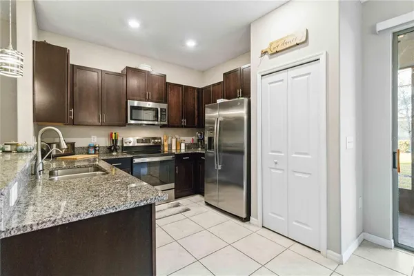 a kitchen with stainless steel appliances granite countertop a refrigerator stove and sink