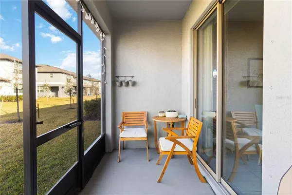 a view of a room with a dining table and chairs