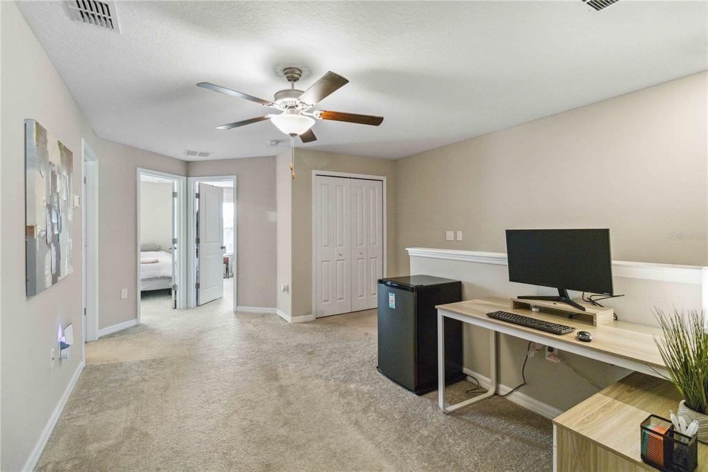 14339 Easy Goer Street Ruskin, FL 33573 - Photo 26 of 49 a view of a workspace with furniture and a ceiling fan