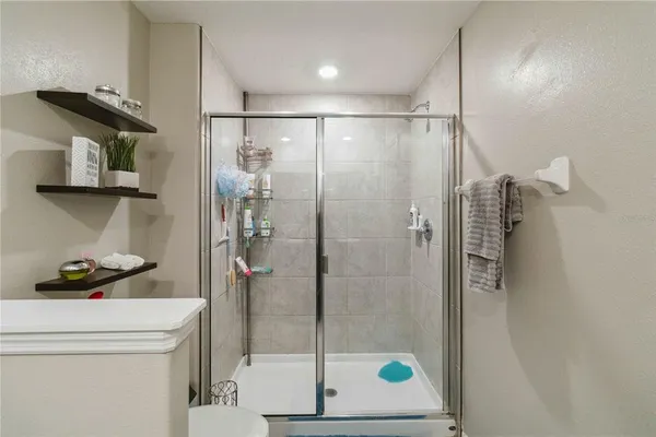 a bathroom with a shower a toilet and a sink