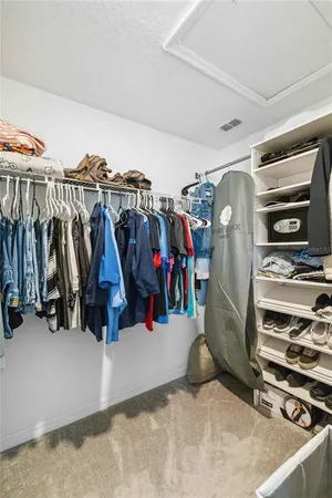 a view of walk in closet with clothes